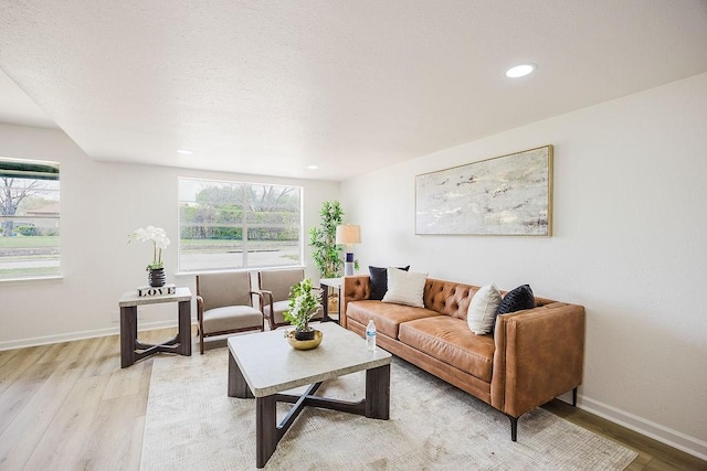 2112 Pontiac Dr, Carrollton, TX 75006 - living room with light wood finished floors, baseboards, recessed lighting, and a textured ceiling
