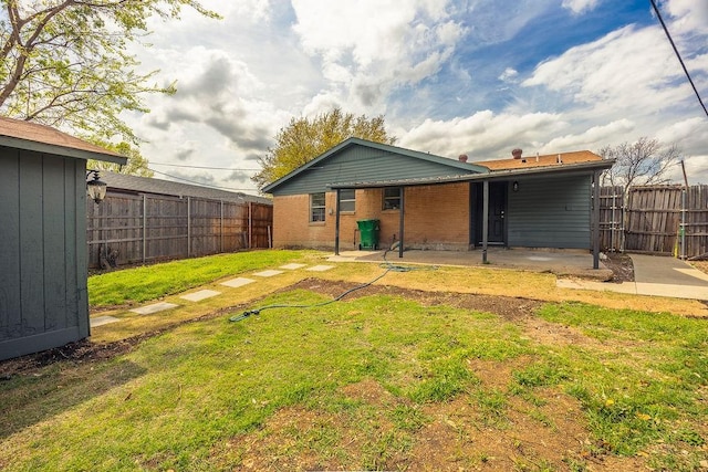 2112 Pontiac Dr, Carrollton, TX 75006 - back of house featuring a fenced backyard, a lawn, a patio, and brick siding