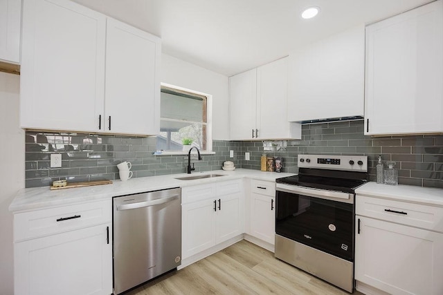 2112 Pontiac Dr, Carrollton, TX 75006 - kitchen featuring light countertops, tasteful backsplash, light wood-type flooring, stainless steel appliances, and a sink