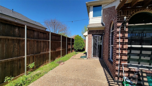 view of patio featuring fence