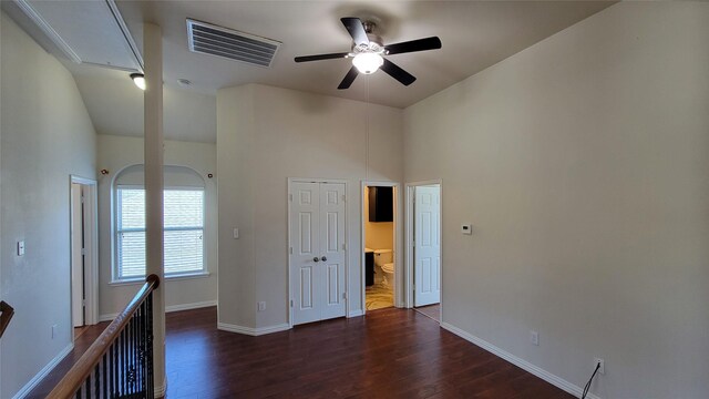 empty room with a ceiling fan, visible vents, attic access, and wood finished floors