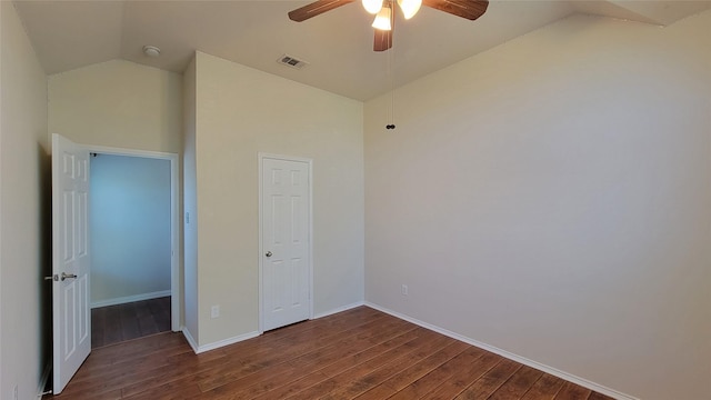 unfurnished bedroom with a ceiling fan, wood finished floors, vaulted ceiling, and visible vents