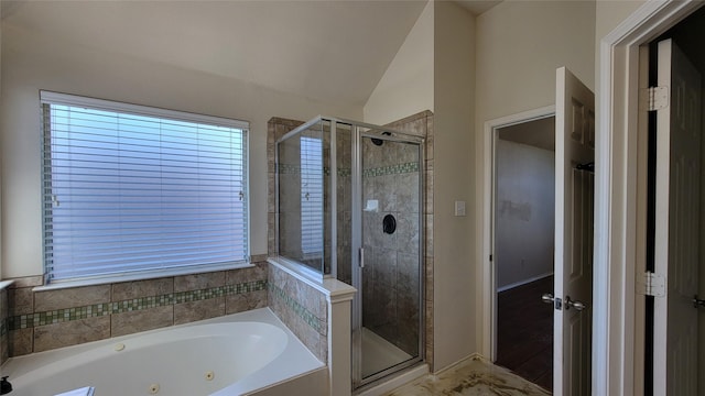 full bath with vaulted ceiling, a stall shower, and a whirlpool tub