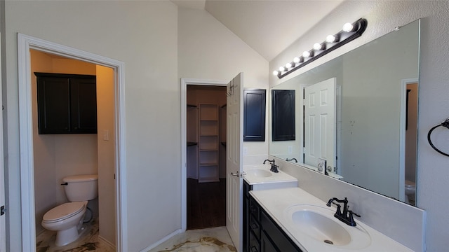 full bath with baseboards, vaulted ceiling, toilet, and vanity