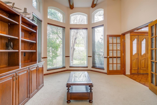 1002 Loch Lomond Dr, Arlington, TX 76012 - living room with plenty of natural light, beam ceiling, and carpet flooring