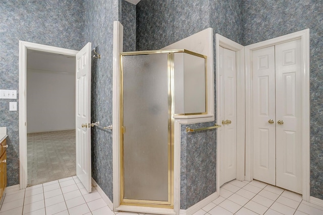1002 Loch Lomond Dr, Arlington, TX 76012 - full bath with a closet, a shower stall, wallpapered walls, vanity, and tile patterned flooring