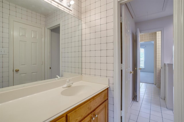 1002 Loch Lomond Dr, Arlington, TX 76012 - bathroom featuring tile walls, tile patterned flooring, and vanity