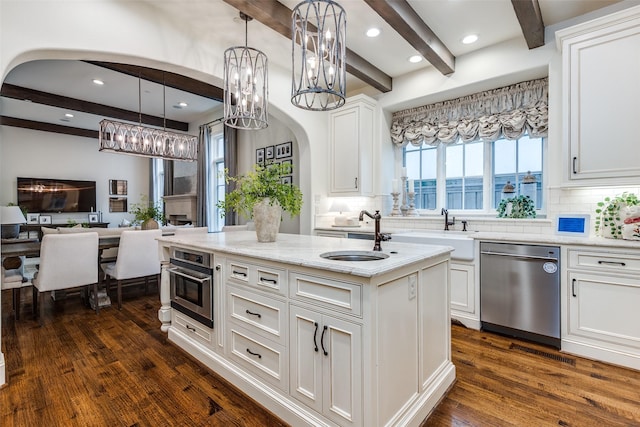 3404 Marquette St, University Park, TX 75225 - kitchen with appliances with stainless steel finishes, a sink, arched walkways, beamed ceiling, and backsplash