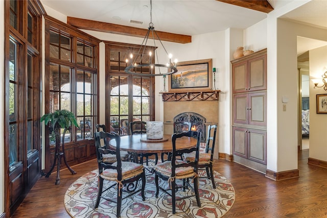 dining area featuring beam ceiling, dark wood-style floors, and an inviting chandelier
