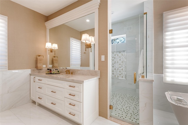 full bath with a freestanding bath, vanity, and a stall shower