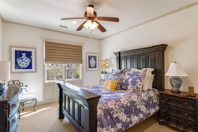 carpeted bedroom featuring visible vents, crown molding, and a ceiling fan