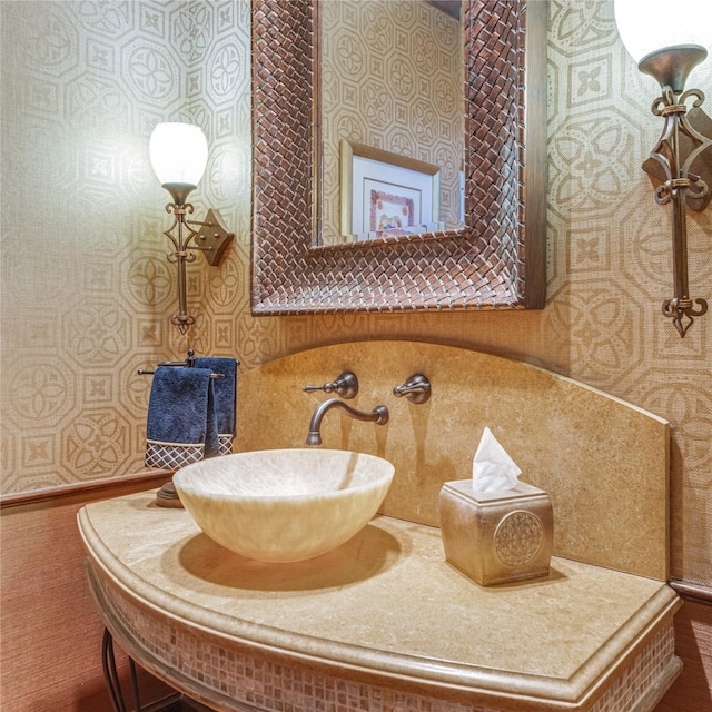 bathroom with a sink and wallpapered walls