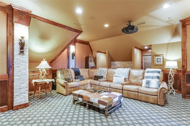 carpeted living area with wooden walls, recessed lighting, and visible vents