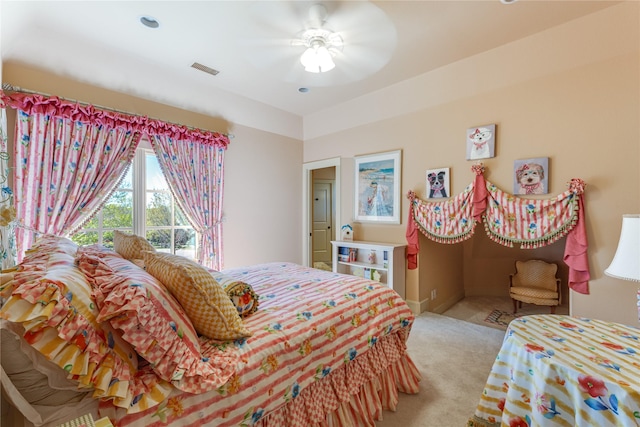 bedroom featuring a ceiling fan, visible vents, light carpet, and baseboards