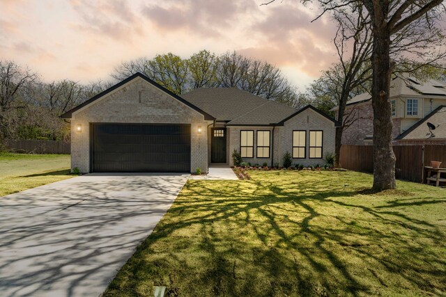view of front facade featuring brick siding, driveway, and fence