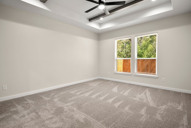 unfurnished room featuring carpet floors, baseboards, beamed ceiling, and ceiling fan