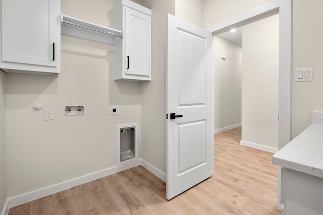 laundry area featuring hookup for an electric dryer, light wood-style flooring, baseboards, cabinet space, and hookup for a washing machine