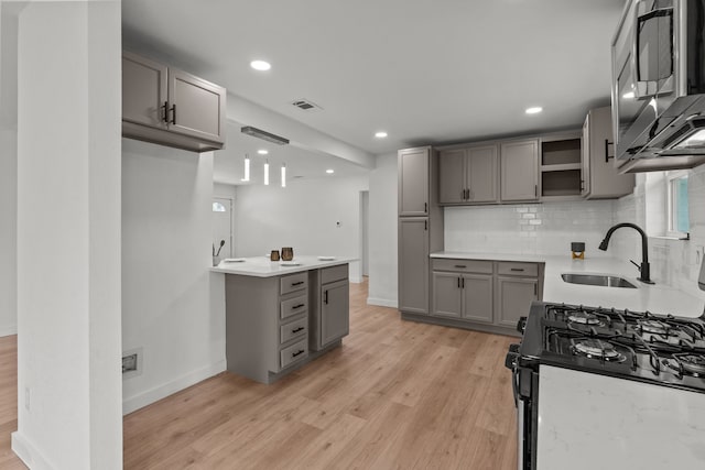 2225 Mack Ln, Dallas, TX 75227 - kitchen featuring range with gas stovetop, gray cabinets, stainless steel microwave, a sink, and recessed lighting