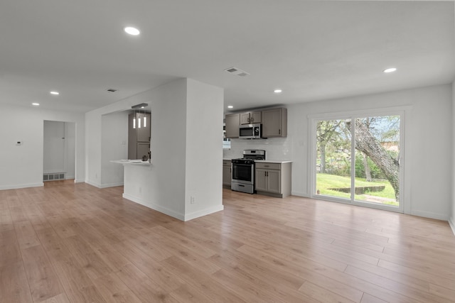2225 Mack Ln, Dallas, TX 75227 - unfurnished living room featuring light wood finished floors, recessed lighting, and baseboards