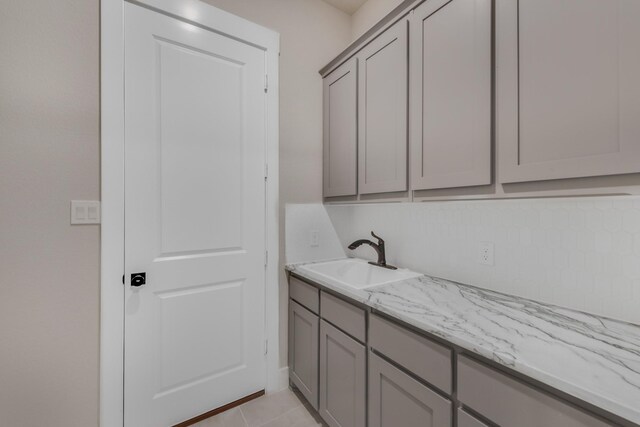 4133 Old Springtown Rd, Weatherford, TX 76085 - laundry area with a sink and light tile patterned flooring