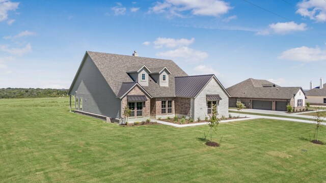 4133 Old Springtown Rd, Weatherford, TX 76085 - view of front of home featuring a standing seam roof, metal roof, stone siding, a front lawn, and a garage