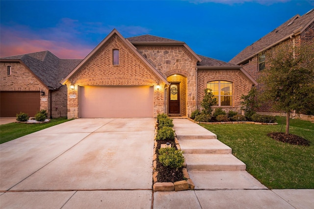 view of front of property with driveway, brick siding, an attached garage, a shingled roof, and a front yard