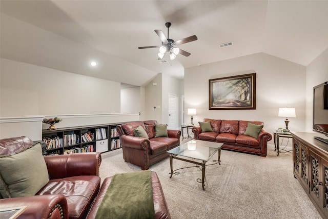 living room featuring lofted ceiling, a ceiling fan, visible vents, and light colored carpet