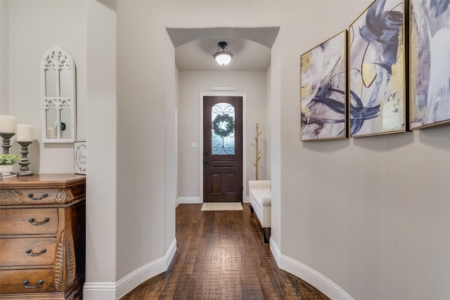 entrance foyer with dark wood finished floors and baseboards