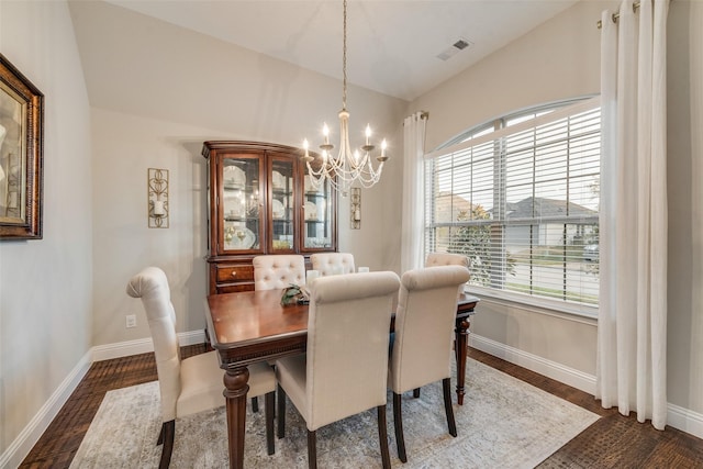 dining room featuring dark wood-style floors, vaulted ceiling, visible vents, baseboards, and a chandelier