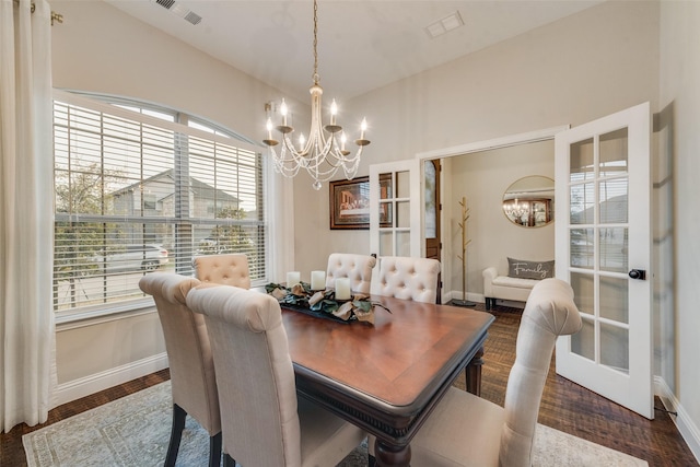dining area with baseboards, a notable chandelier, and visible vents