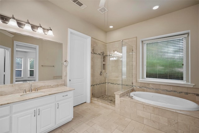 bathroom featuring a bath, visible vents, recessed lighting, vanity, and a stall shower