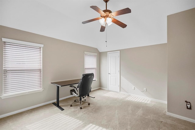 carpeted office space with baseboards, lofted ceiling, and ceiling fan