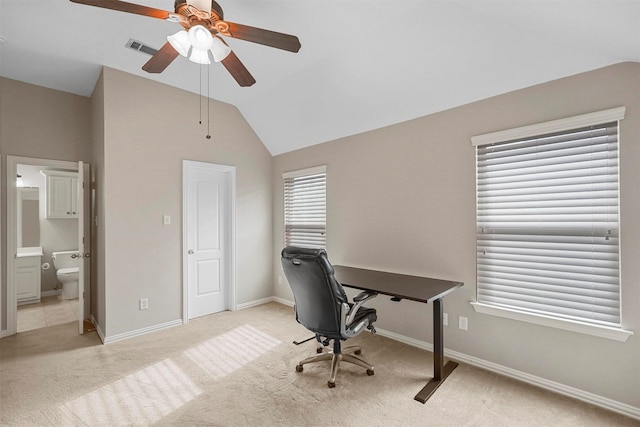 office space with visible vents, baseboards, ceiling fan, carpet floors, and vaulted ceiling