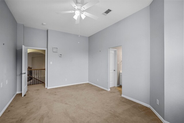 unfurnished bedroom with ceiling fan, baseboards, light colored carpet, and visible vents