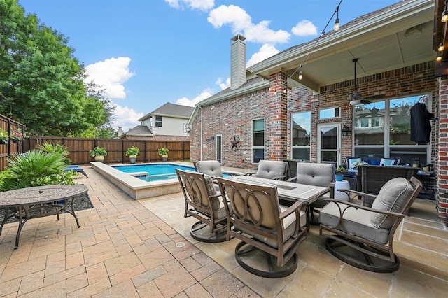 view of patio / terrace featuring outdoor lounge area, outdoor dining area, a fenced backyard, and a fenced in pool