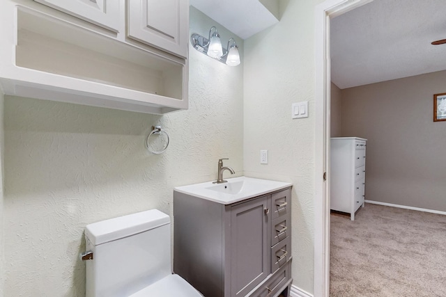 623 Middale Rd, Duncanville, TX 75116 - half bath with vanity, toilet, a textured wall, and baseboards
