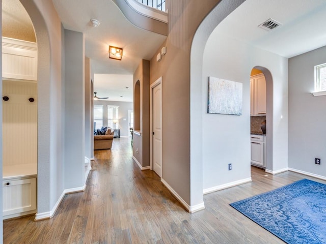 3009 Morning Star Dr, Little Elm, TX 75068 - hallway featuring arched walkways, baseboards, visible vents, and wood finished floors