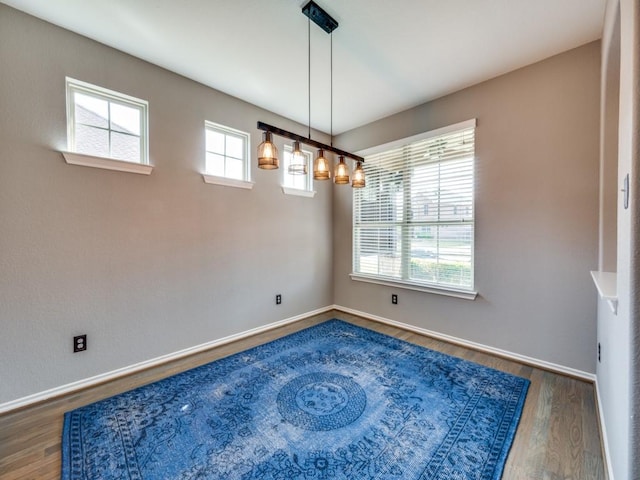 3009 Morning Star Dr, Little Elm, TX 75068 - unfurnished dining area featuring baseboards and wood finished floors