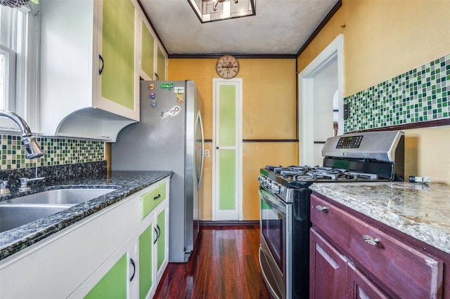 635 Richmondell, Dallas, TX 75211 - kitchen with appliances with stainless steel finishes, a sink, tasteful backsplash, dark wood-type flooring, and dark brown cabinets