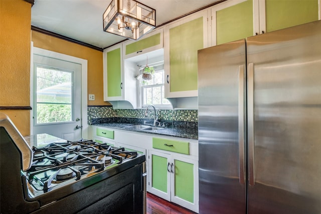 635 Richmondell, Dallas, TX 75211 - kitchen with freestanding refrigerator, a sink, gas range, backsplash, and a chandelier