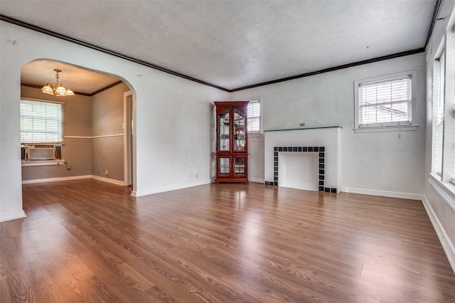 635 Richmondell, Dallas, TX 75211 - unfurnished living room with arched walkways, a chandelier, crown molding, healthy amount of natural light, and a textured ceiling