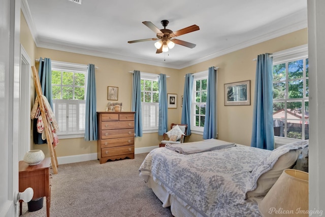 carpeted bedroom featuring a ceiling fan, baseboards, and ornamental molding