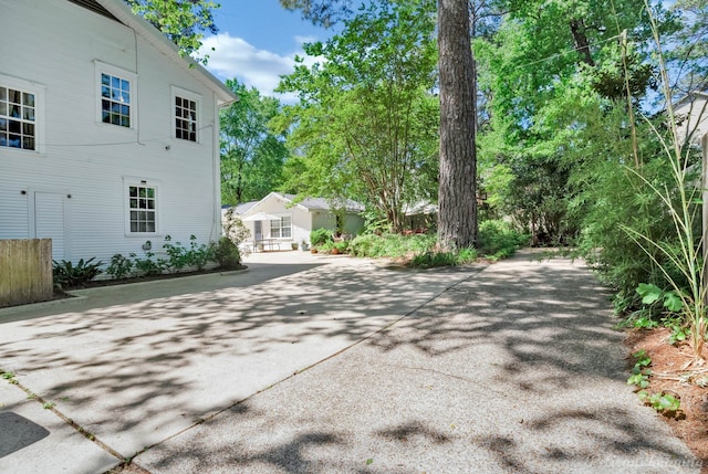 view of side of home featuring concrete driveway