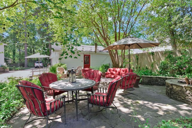 view of patio / terrace featuring outdoor dining area and fence