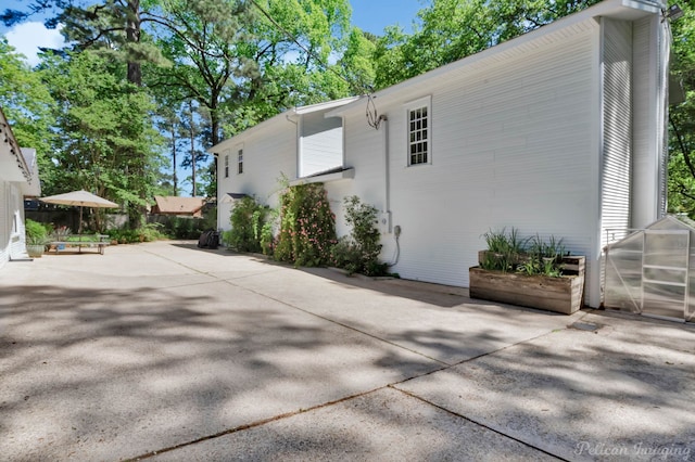 view of side of home with a patio area