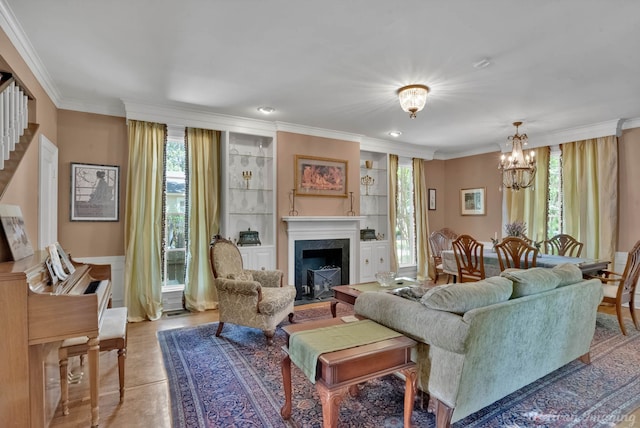 living room featuring crown molding, plenty of natural light, a notable chandelier, and a fireplace