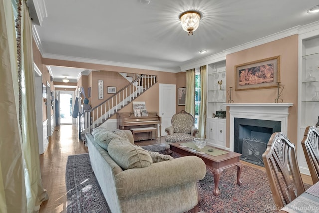 living area featuring ornamental molding, stairway, wood finished floors, and a fireplace with flush hearth