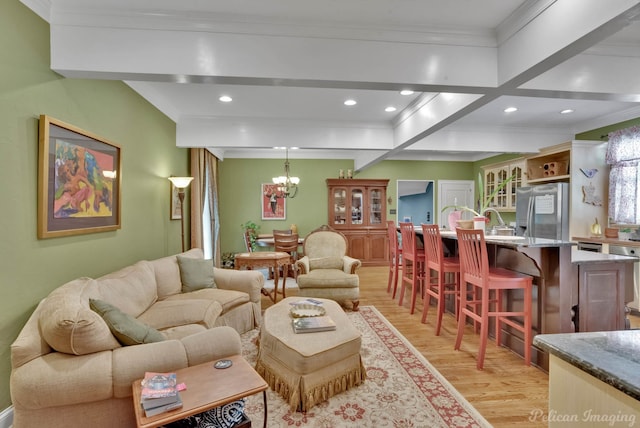 living area featuring ornamental molding, recessed lighting, a chandelier, and light wood-style floors