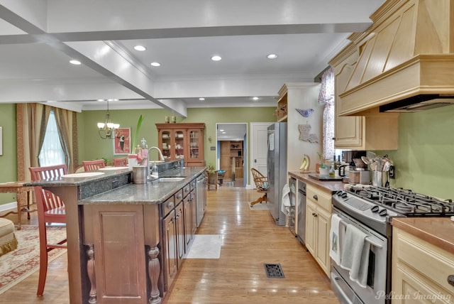 kitchen with a breakfast bar, premium range hood, crown molding, stainless steel appliances, and a sink