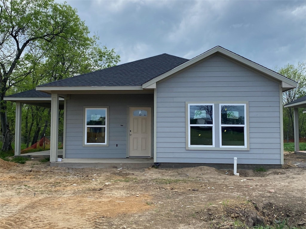 view of front of property with roof with shingles